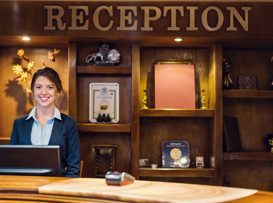 Charming hotel receptionist looking at camera