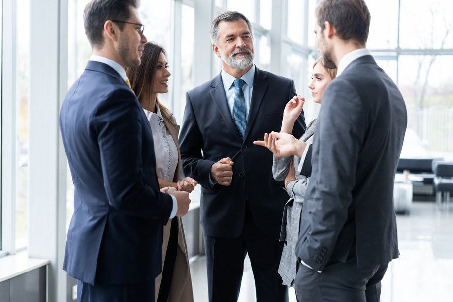 Image of business partners discussing documents and ideas at meeting.