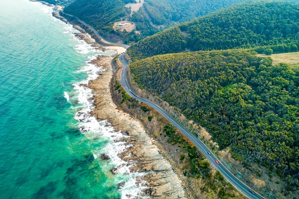 Cars driving on Great Ocean Road, Victoria, Australia - aerial view
